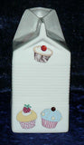 Milk carton shaped jug off white ceramic decorated with colourful cupcakes